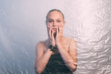 Female aging. Defocused woman portrait. Skin rejuvenation. Wrinkled texture worried young lady...