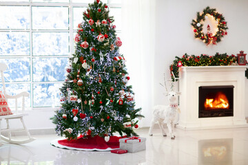 Decorated room with Christmas tree and fireplace