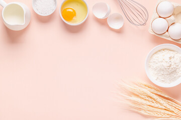 Fototapeta premium Ingredients for baking on light pink background.