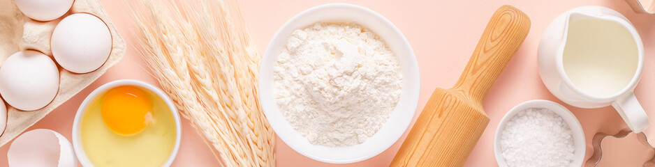 Ingredients for baking on light pink background.