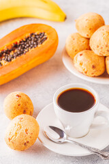 Traditional Brazilian breakfast - cheese bread, coffee, ripe fruit.