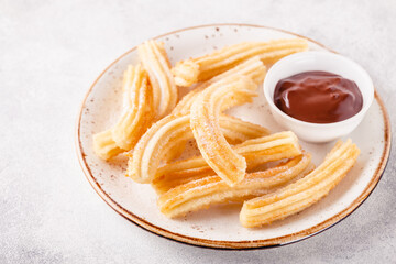 churros with powdered sugar and chocolate sauce