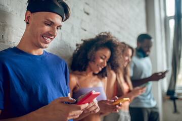 Group of young people using their smartphones