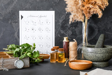 Alchemical symbols and ingredients for preparing potions on dark background
