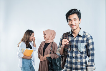 Portrait of Happy young man university carrying bags and campus young people chatting on isolated white