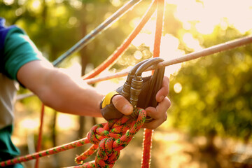 Teenage boy climbing in adventure park