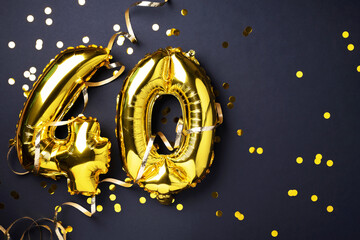 Gold foil balloon number, digit forty. Birthday greeting card with inscription 40. Anniversary celebration event. Banner. Golden numeral, black background. Numerical digit, light bokeh, glitter.