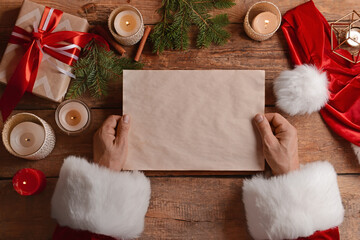 Santa Claus with empty letter at table