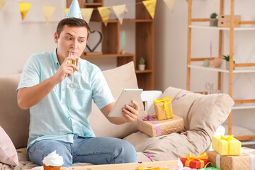 Young man celebrating Birthday at home due to coronavirus epidemic