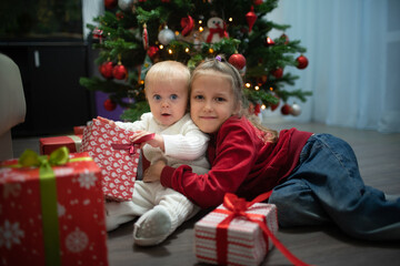 Fototapeta na wymiar Two children near the Christmas tree