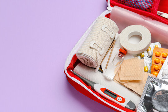First aid kit on color background, closeup