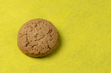 Oatmeal cookies on a blurry yellow background.