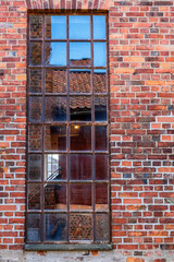 Old beautiful window on an industrial building of bricks