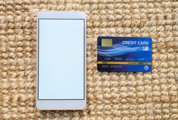Credit card and mockup smart phone image. White screen. Online shopping concept. Suitable for illustration.