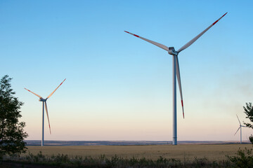 Fototapeta na wymiar Wind turbine renewable energy source summer landscape