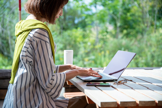 Woman Teleworking on an Outdoor Office as New Normal Work Style