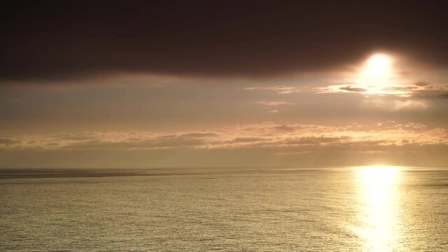 Seascape. Dramatic sunset over sea with dark clouds moving over water surface, time lapse. Nature evening landscape.