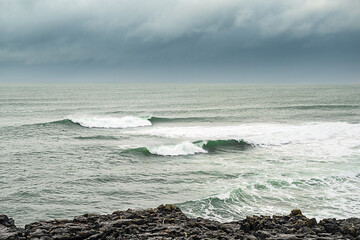 Powerful waves in the ocean, Rough stone coast line. West coast of Ireland, Blue cloudy sky, Nobody.