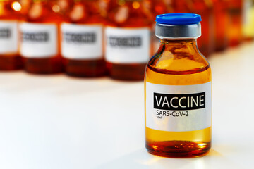 Sars-cov-2 vaccine vial bottles on white table