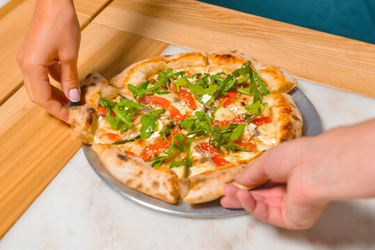 Image of friends hands taking slices of pizza. Top view, flat lay. Italian cuisine concept, eating delicious pizza.