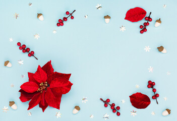 Christmas holiday card - Xmas red flower poinsettia, silver snowflakes, acorns on blue paper background.