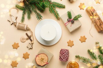 Obraz na płótnie Canvas Trendy handmade soy candle, natural decorations, gingerbread cookies on beige background. Christmas zero waste eco friendly gift concept.