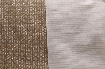 Cardboard surface covered with bubble wrap and styrofoam packaging protection background and texture
