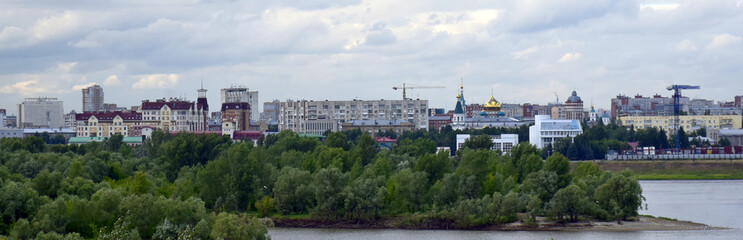 Fototapeta na wymiar View of the embankment and the historical part of the city of Omsk in Russia from the Leningrad bridge on the Irtysh river-6