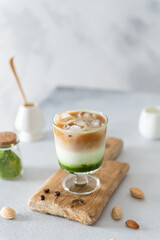 Iced matcha and espresso fusion Coffee. Iced Matcha and Espresso Latte in a glass. Side view, copy space. Spirulina cold drink. Super foods recipe, dieting, healthy eating