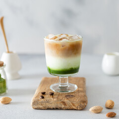 Matcha espresso. Trendy coffee drink with spirulina. Green tea coffee, matcha green tea with milk and coffee. Colorful layer drink. Menu, recipe. Side view, copy space for text