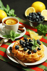 Belgian waffles with blueberry and a cup of tea with lemon