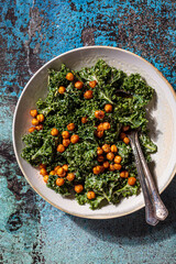 Vegan caesar salad. Fried chickpea salad with kale in white bowl, top view. Vegan food concept.