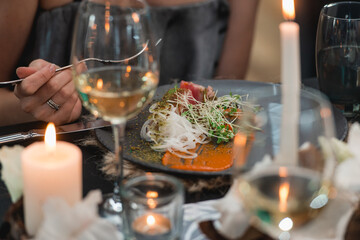 woman eat grilled tuna steak with onion on a grey ceramic plate. Selective focus.