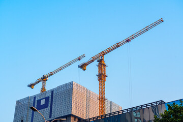 Construction crane on the background of the sky. Construction site.