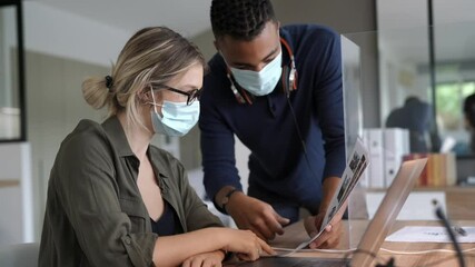 Start-up people working in co-working space office, wearing face mask during 19-ncov pandemic - Powered by Adobe