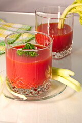 Freshly prepared tomato juice with celery leaves in a glass Cup is on the table. The concept of healthy food. It is an element of vegetarianism, keto diet, paleo diet
