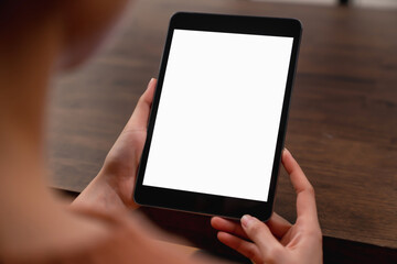 Mock up of woman hand holding digital tablet and touching blank screen.
