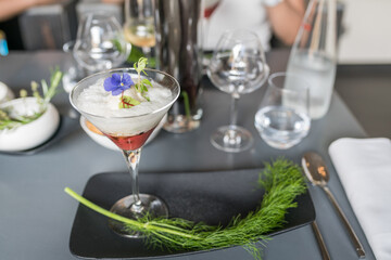 Appetizer of French cuisine, a glass of exquisite blueberry mousse dessert with a leaf decoration