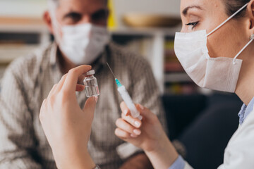close up of woman doctor holding vaccine, corovnavirus concept