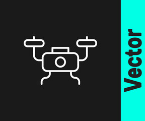 White line Drone flying icon isolated on black background. Quadrocopter with video and photo camera symbol. Vector.
