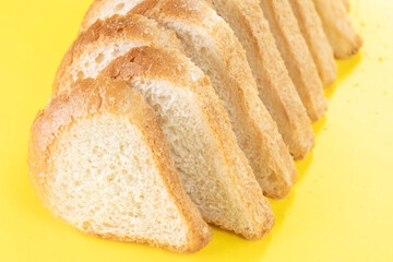 Sliced white bread on yellow background, top view