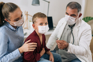 mother with her child receives coronavirus vaccine at the doctor office