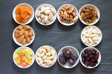 Mix of nuts and dried fruits in small bowls. Healthy and tasty snack 