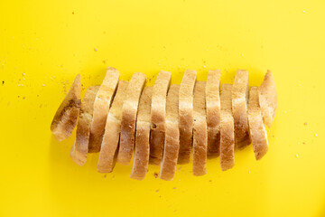 Sliced white bread on yellow background, top view