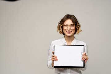 Naklejka premium Business woman in a light shirt and a folder with documents in hands cropped view of work