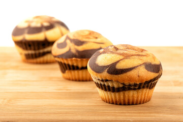 Delicious homemade muffins on a wooden background.