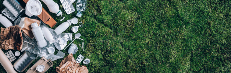 Reuse garbage, recycle, plastic free. Food plastic packaging, trash on green moss background after picnic in forest. Top view. Copy space. Recycling plastic. Environmental pollution, ecology concept. - 393049222