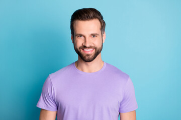 Portrait of young handsome attractive cheerful smiling good mood man look camera isolated on blue color background
