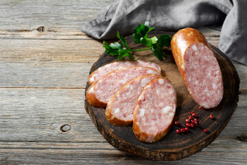Sausage. Smoked sausage with spices on a wooden serving Board. Tasty meat sausages made from turkey meat. Copyspace	