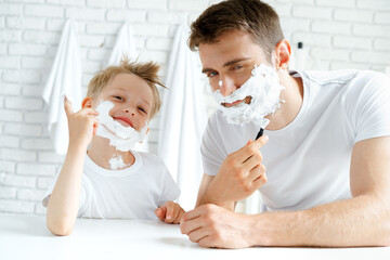 Father and his little son shaving together